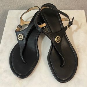 Black leather gold accents Michael Kors sandal, slight wedge 1.5” heel. Size 7